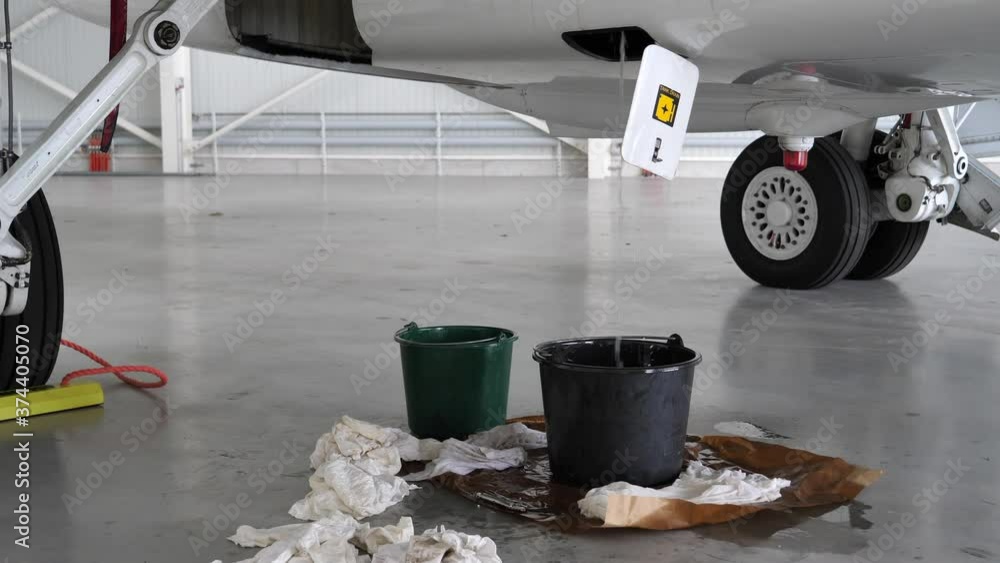 Kerosene fuel leaking out of drain of airplane fuselage Interior Detail
