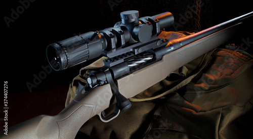 Bolt action rifle with a scope on a pack with orange rim lighting from the back photo
