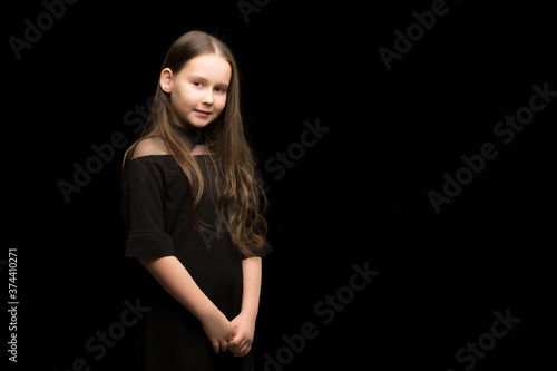 Close-up.Portrait of a cute little girl on a black background.