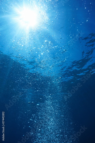 Air bubbles with sunshine underwater in the ocean, natural scene