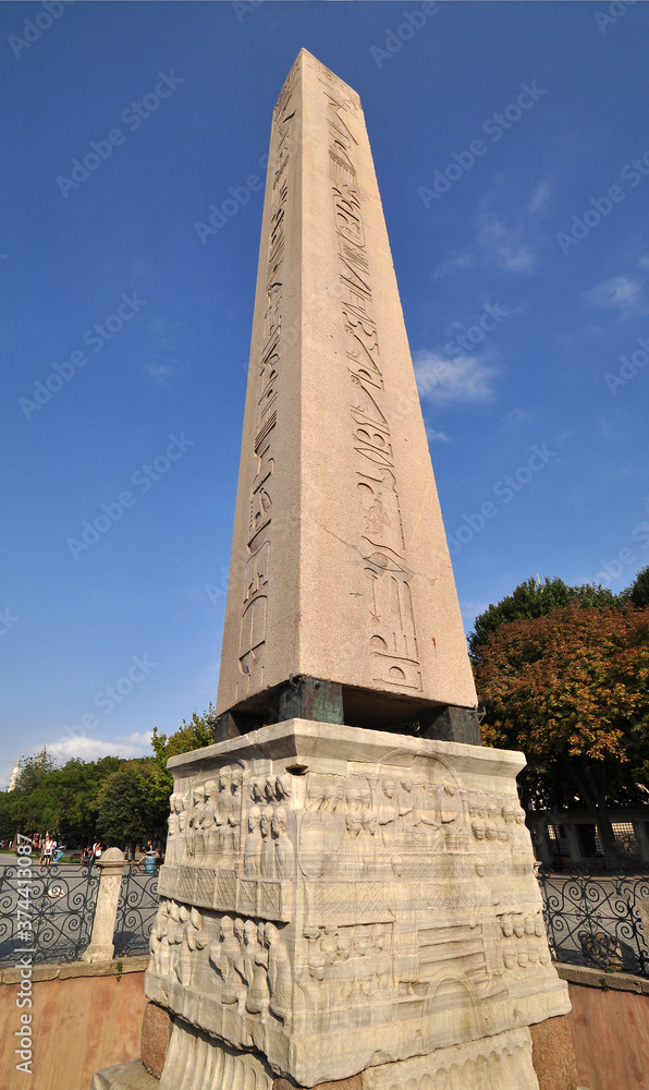 The Egyptian obelisk seen closeup with its elegant carving on red granite.