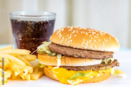 A fast food with French fries and beef burger