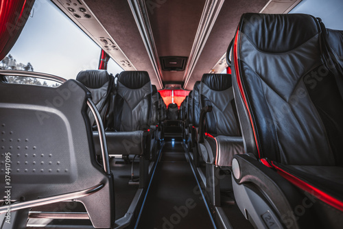 Photos An empty interior of a regular intercity bus with rows of leather numbered seats