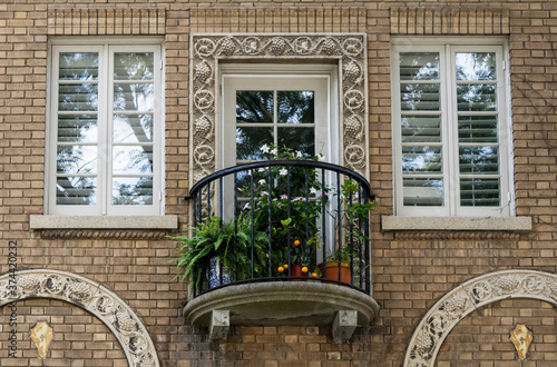 Wallpaper Mural Vintage-style round balcony with plants and fruits  of an old brick building  Torontodigital.ca