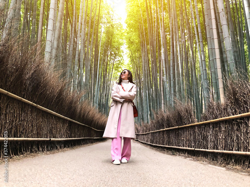 Asian woman traveling at Bamboo Forest in Kyoto, Japan.