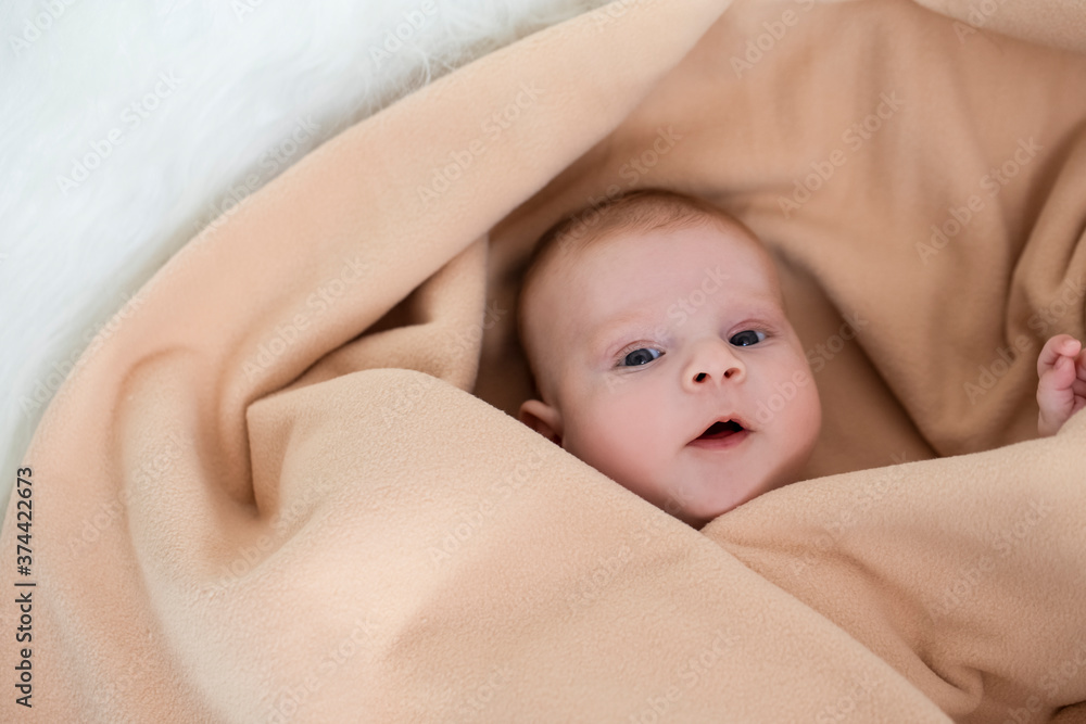 Closeup Portrait of Smiling Newborn Baby Boy Peacefully Wrapped in Pale Blanket Closeup Portrait of Smiling Newborn Baby Boy Peacefully Wrapped in Pale Blanket