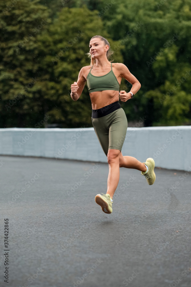 Fototapeta premium Caucasian Female Runner During Her Regular Training Exercises Outdoor.