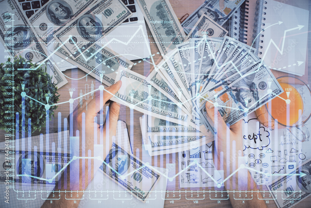Multi exposure of financial graph drawing hologram and USA dollars bills and man hands. Analysis concept. Multi exposure of financial graph drawing hologram and USA dollars bills and man hands. Analysis concept.