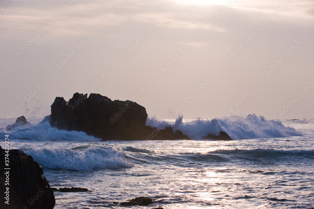Sea coast rocks and wave with the beaytiful sunrise sunshine.