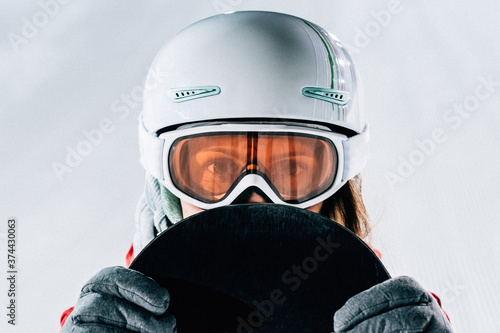 Closeup portrait of woman in helmet and mask with on ski resort © Iurii