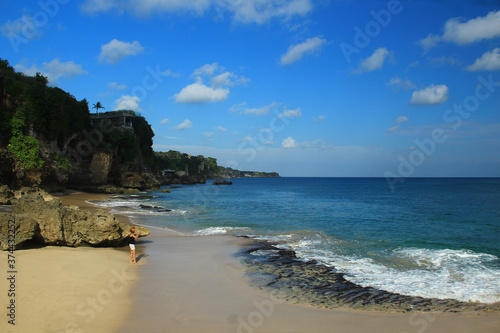 A woman walking on Balangan beach Bali Indonesia