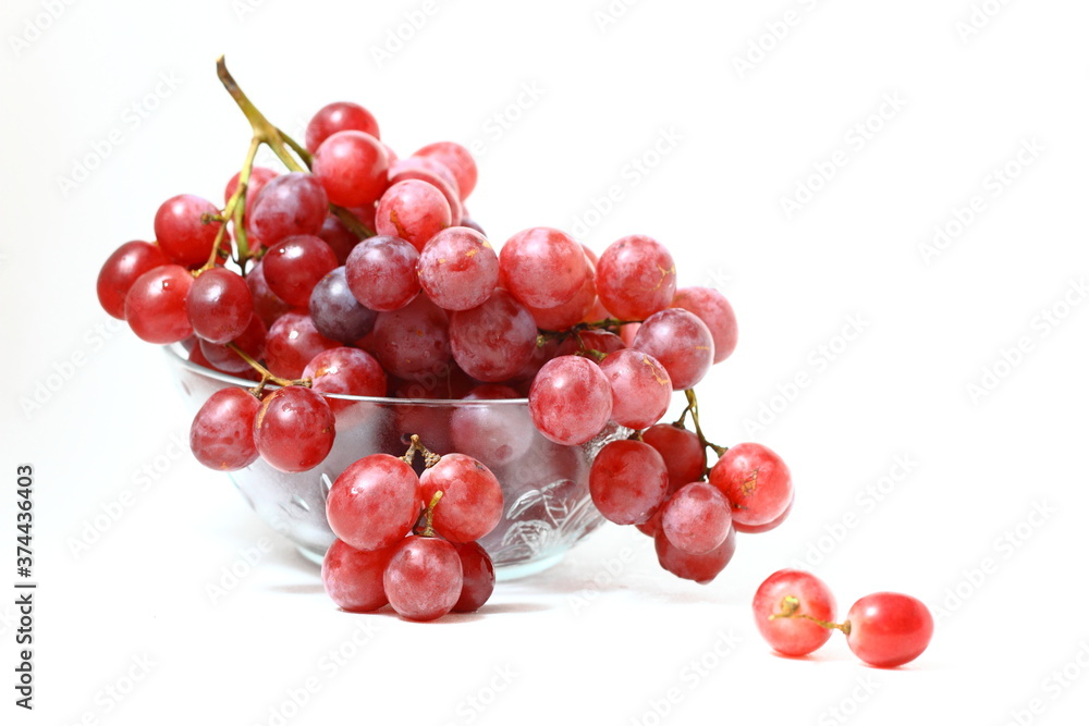bunch red grapes with transpararnt bowel isolated on white background