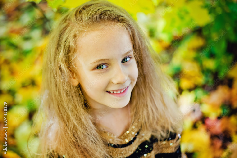 A little funny girl is lying on yellow leaves in the forest. A child on a walk in the autumn Park. Preschool girl on the street A little funny girl is lying on yellow leaves in the forest. A child on a walk in the autumn Park. Preschool girl on the street
