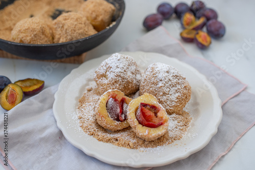 Canvas Print Typical Austrian plum dumplings made of leavened dough and fresh plums