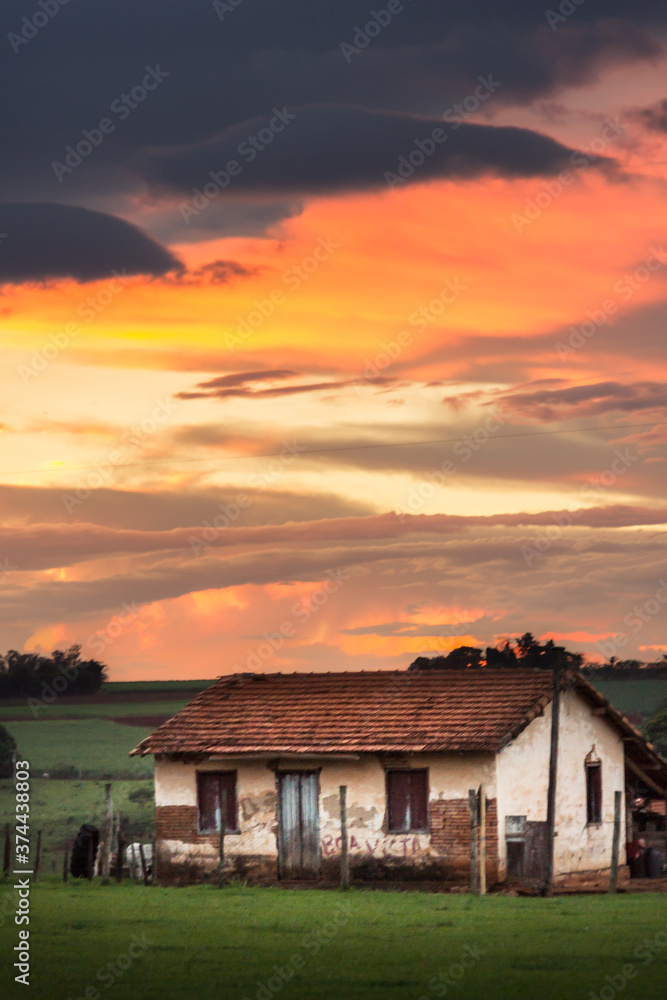 old house farm in a colourful sunset sky