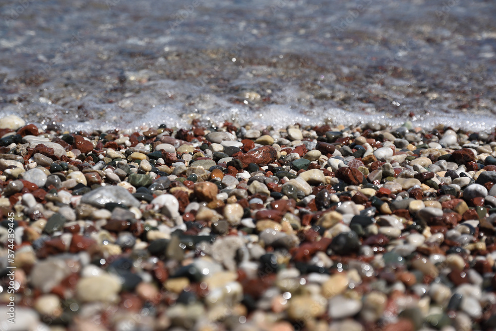 Pebbles in the sea surf on the Aegean coast Pebbles in the sea surf on the Aegean coast