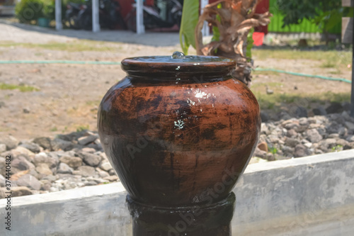 traditional Javanese water made of clay is usually called a Gentong in a garden