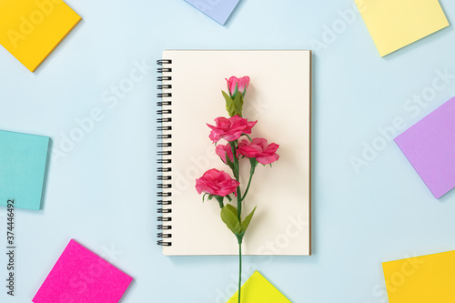 Wallpaper Mural Spiral Notebook or Spring Notebook in Unlined Type and Multi Color Sticky Note and Rose Flower on Blue Pastel Minimalist Background. Spiral Notebook Mockup on Center Frame Torontodigital.ca