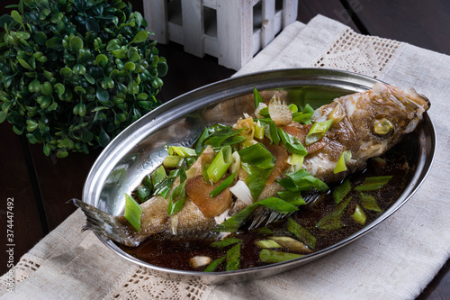 steamed lapu lapu with sweet soy sauce and sesame oil photo