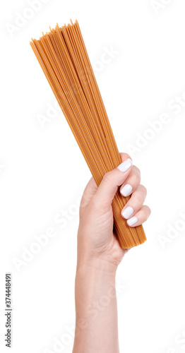 Fotografía Hand with dark durum wheat spaghetti, raw pasta, isolated on white background