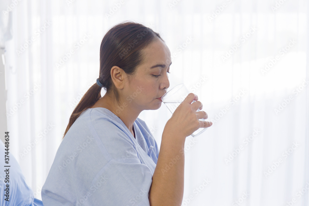 Asian female patients drinking water Asian female patients drinking water