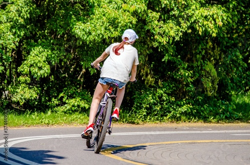 Wallpaper Mural Cyclist ride on the bike path in the city Park
 Torontodigital.ca