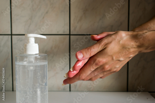 Woman using hand sanitizer. Importance of personal hygiene during pandemic around the world