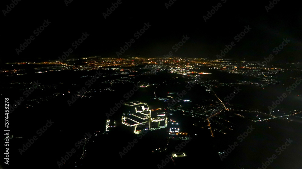 Aerial shot of cities during the night seen from airplane Aerial shot of cities during the night seen from airplane