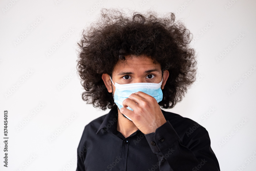 Latin american model fixing a medical mask close up, white background Latin american model fixing a medical mask close up, white background