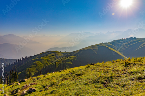 sunrise over the lush green mountains - clear sky and grass with dew - siri paye meadows
