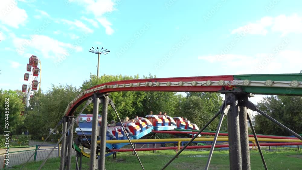Children's carousel with cars in the amusement Park in summer. Children's carousel with cars in the amusement Park in summer.