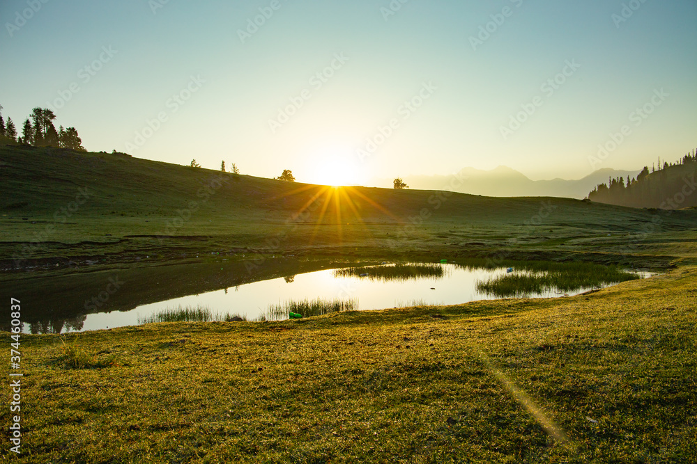 sunrise over the lake and water reflection - Siri paye Medows sun rays