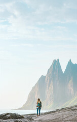 Traveler woman walking in Norway travel lifestyle active vacations outdoor eco tourism summer holidays tour Okshornan peaks landscape Senja island