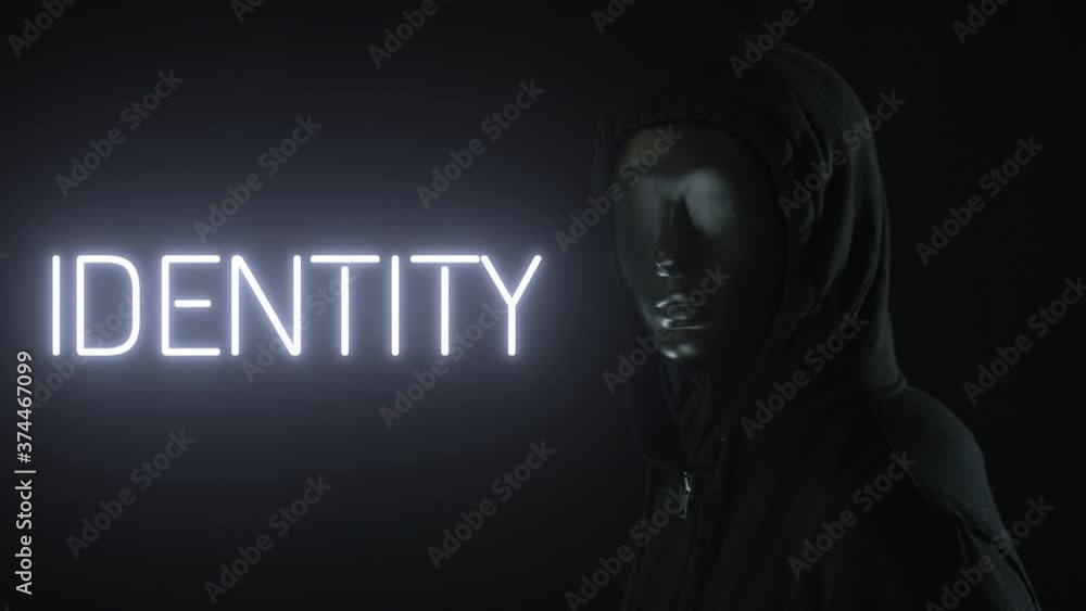 Unknown man wearing black mask and the light revealing IDENTITY word Unknown man wearing black mask and the light revealing IDENTITY word