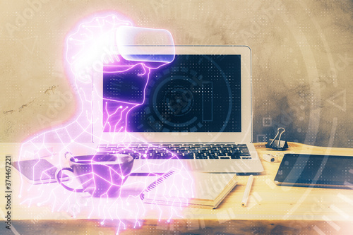 Computer on desktop with AR theme icon. Multi exposure. Concept of augmented reality. © peshkova