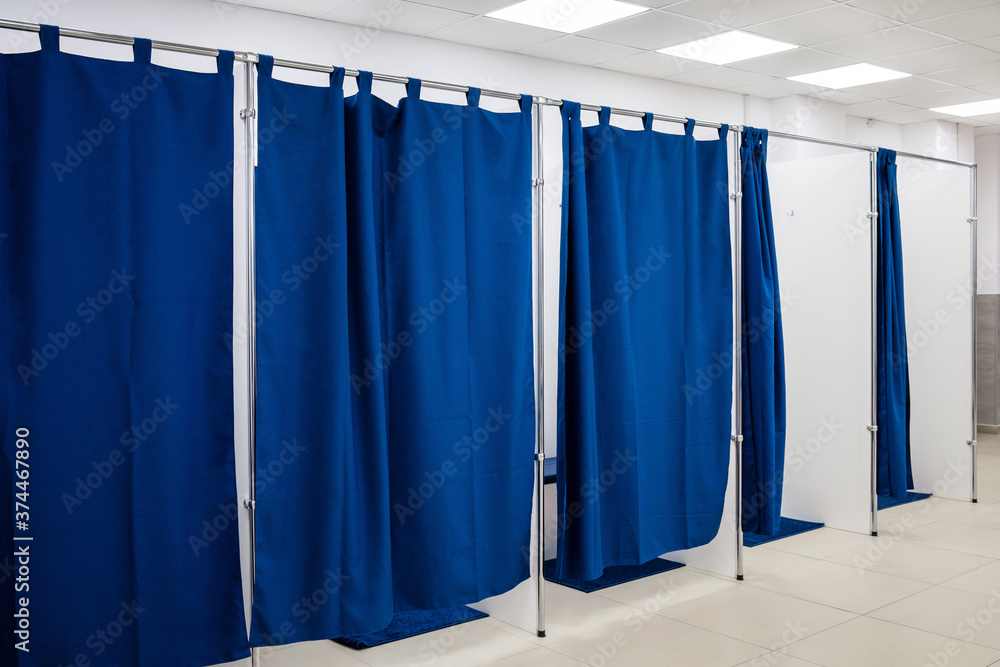 Fitting room with blue curtains in a clothing store. Shopping concept