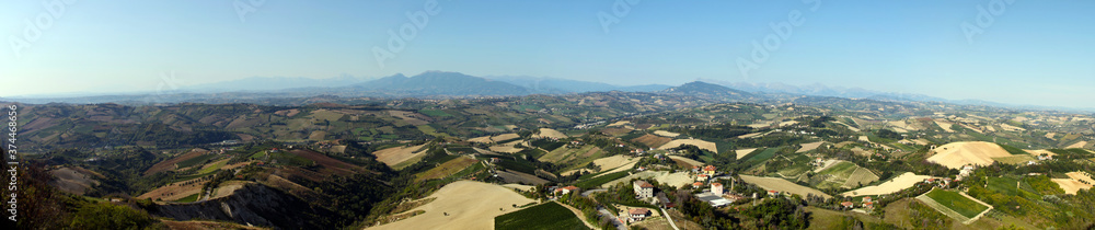 Italian rural landscape Marche countryside with plowed fields ready for sowing, clear sky without clouds, Mediterranean vegetation, Apennine mountains in the background. Seismic area near Amatrice