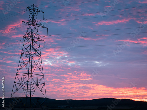 high voltage tower with power lines. Taken during amazing sunset