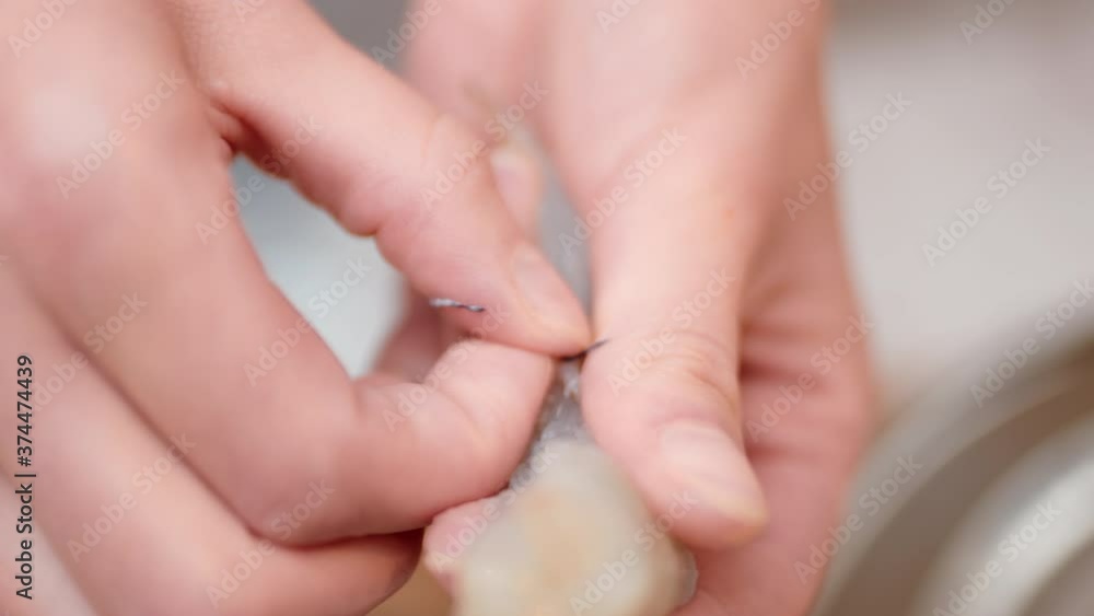 Cleaning Shrimp/prawn procedure by peeling and deveining in 4K. Using a knife, cut a shallow incision and lifting out the vein from the shrimp. Cleaning Shrimp/prawn procedure by peeling and deveining in 4K. Using a knife, cut a shallow incision and lifting out the vein from the shrimp.