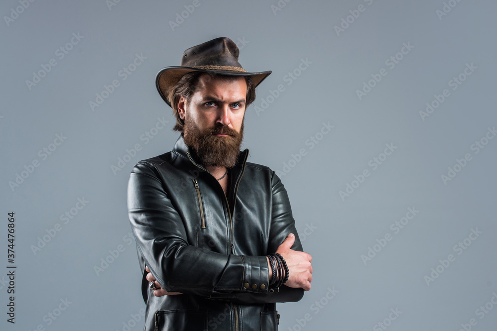 Brutal man cowboy hat leather jacket, confident person concept Brutal man cowboy hat leather jacket, confident person concept