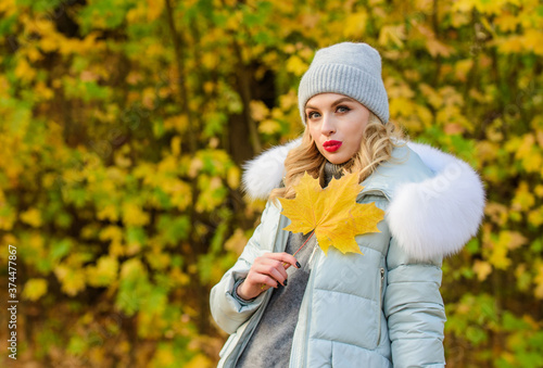 Sharing love to nature. woman in hat. walking in park. girl relax among fallen leaves. sporty girl with puffed jacket. wear comfort clothes. autumn leaves beauty. warm clothes for fall season