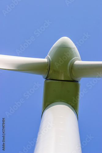 Detail at a Wind turbine from below against a clear blue sky