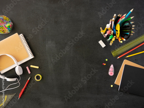 Back to school mockup. Top view black chalkboard framed with student's supplies and stationery. Copy space for your text