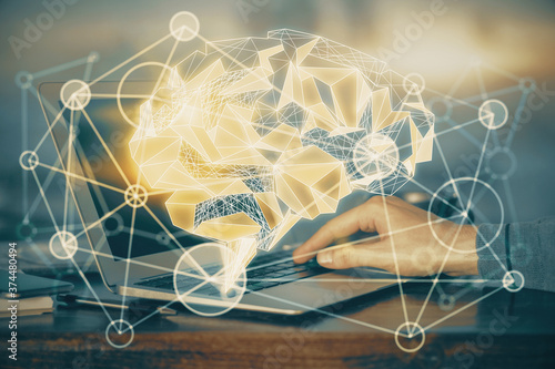 Man typing on keyboard background with brain hologram. Concept of big Data. Double exposure.