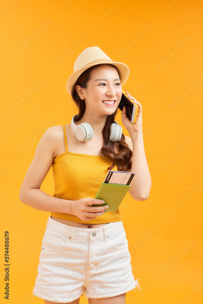 Asian woman got tickets to travel on summer, Using smartphone and holding passport. Asian woman got tickets to travel on summer, Using smartphone and holding passport.