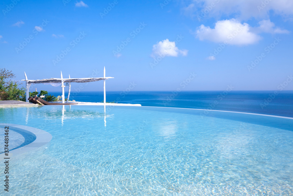 Infinity Pool at tropical beach with blue sky