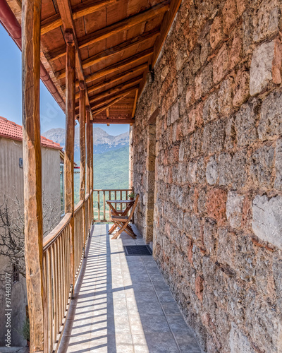 view from traditional stone wall house balcony with wooden railngs