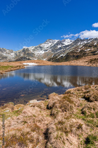 A lake during the summer in the Italian Alps, near the town of Madesimo, Italy - June 2020.