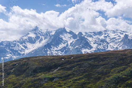 Fototapeta Naklejka Na Ścianę i Meble -  The snow-capped mountains of the Spluga valley during early summer, near the town of Madesimo, Italy - June 2020.