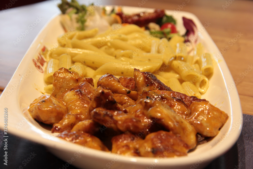 Chicken, rice and salad on a serving plate Chicken, rice and salad on a serving plate